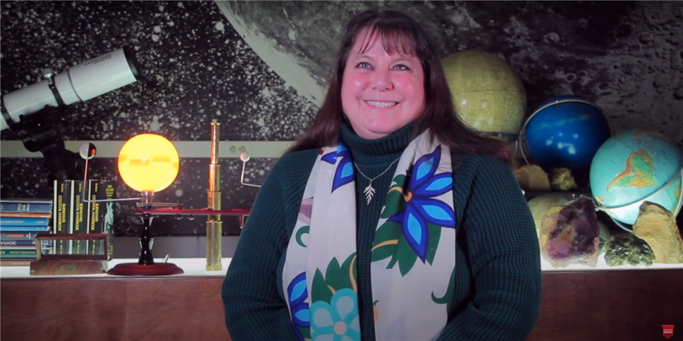 SPPS American Indian Curriculum TOSA Julie Downwind with globes and fossils in the background 